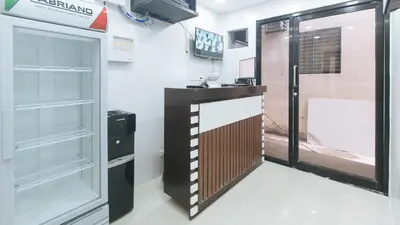 a room with an empty refrigerator and a door at RedDoorz @ El Grande Inn Santa Cruz Manila in Manila