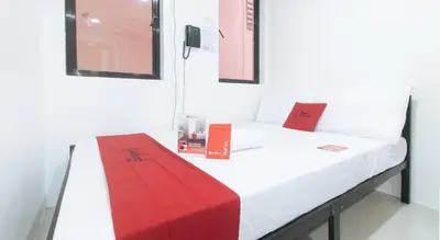 a room with a bed with a red box on it at RedDoorz @ El Grande Inn Santa Cruz Manila in Manila