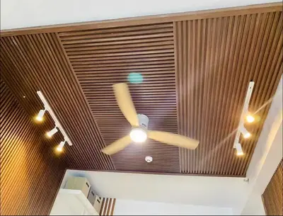 a ceiling fan and lights in a room at Muji-Inspired hōme-tél in the heart of Makati in Manila