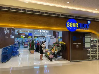 a woman standing in front of a shopping mall at Muji-Inspired hōme-tél in the heart of Makati in Manila