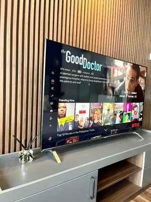 a flat screen tv sitting on top of a shelf at Muji-Inspired hōme-tél in the heart of Makati in Manila