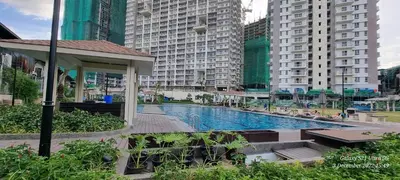 a swimming pool in a city with tall buildings at Apartment in Pasig in Manila