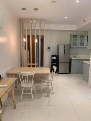 a kitchen with a table and chairs and a refrigerator at US Embassy Roxas Blvd, Ermita, Manila 1 Bedroom ComfySuite in Manila