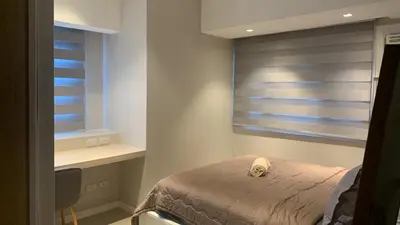 a bedroom with a bed and a window with blinds at US Embassy Roxas Blvd, Ermita, Manila 1 Bedroom ComfySuite in Manila
