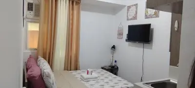 a small room with a bed and a television at JJMC HOMESTAY 36 With Netflix and Unli Wifi in Manila