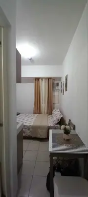 a small room with a bed and a table in it at JJMC HOMESTAY 36 With Netflix and Unli Wifi in Manila