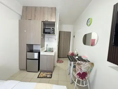 a small kitchen with a table and a kitchen with a microwave at JJMC HOMESTAY 36 With Netflix and Unli Wifi in Manila