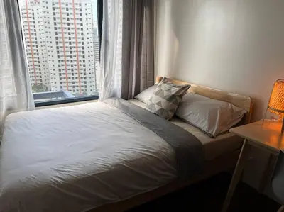 a bed in a room with a large window at Hygge home with Ayala CBD Makati view! NEW! in Manila