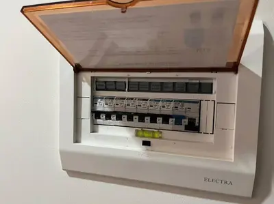 a microwave oven with a wooden top on a wall at Hygge home with Ayala CBD Makati view! NEW! in Manila