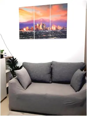 a couch in a living room with a view of a city at Iona Reign's Vacation Unit at FAME Residences in Manila