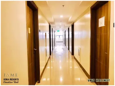 an empty hallway of a building with many doors at Iona Reign's Vacation Unit at FAME Residences in Manila