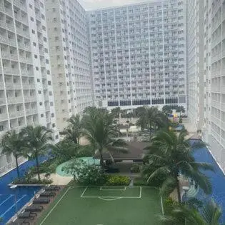a tennis court in the middle of a city with tall buildings at Shore 1 Residences Staycation By Ms Chona in Manila