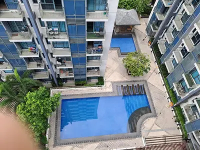 an overhead view of two swimming pools in a building at MRMCONDOTEL in Manila