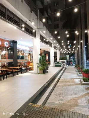 a lobby of a building with tables and benches at MRMCONDOTEL in Manila