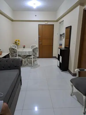 a living room with a couch and a table at MRMCONDOTEL in Manila