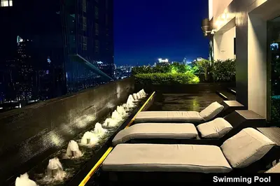 a row of pillows on a building balcony at night at the Gramercy Residences in Manila