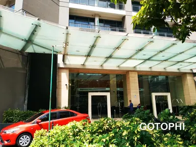 a red car parked in front of a building at the Gramercy Residences in Manila