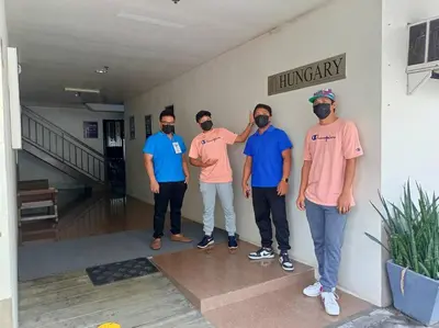 a group of men standing next to a wall at La Casa Hungary 109 Kassel Residences Near NAIA in Manila