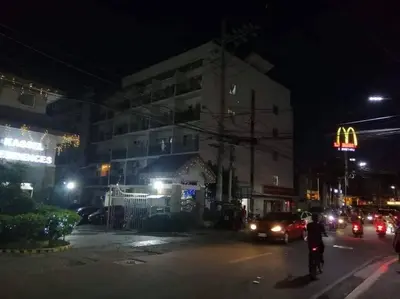 a man riding a bike down a street at night at La Casa Hungary 109 Kassel Residences Near NAIA in Manila