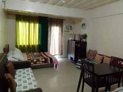 a living room with a bed and a couch and a table at La Casa Hungary 109 Kassel Residences Near NAIA in Manila