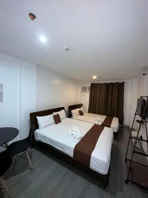 a hotel room with a large bed and a camera at Aden Hotel in Manila