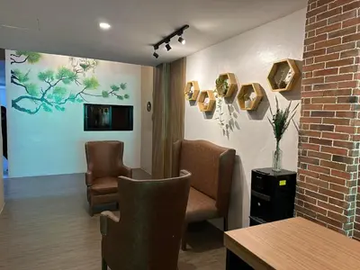 a waiting room with two chairs and a table at Aden Hotel in Manila