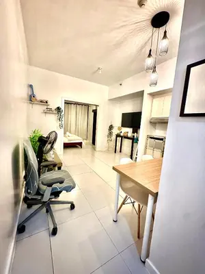 a kitchen and dining room with a table and chairs at One bedroom Apartment with Netflix at Greenbelt Makati in Manila