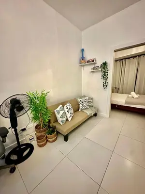 a living room with a couch and a bed at One bedroom Apartment with Netflix at Greenbelt Makati in Manila