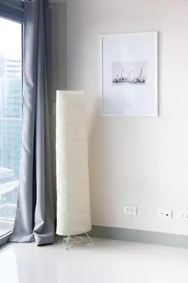 a white room with a picture and a lamp at Uptown Parksuites Apartments Tower 2 BGC by PH Staycation in Manila