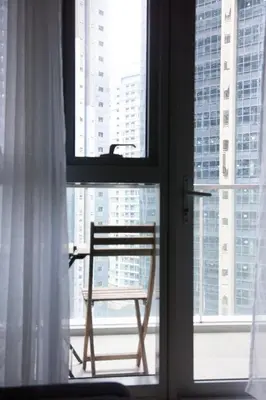 a chair sitting on a window in a room at Uptown Parksuites Apartments Tower 2 BGC by PH Staycation in Manila