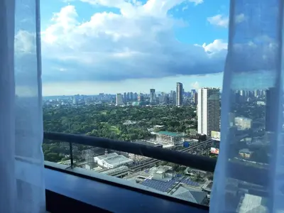 a view of a city from a building at Comfy Bunkbed with Pool in Manila