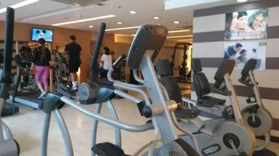 a gym with a bunch of exercise bikes in it at Comfy Bunkbeds at BSA in Manila
