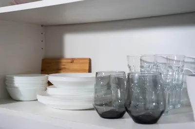 a group of glasses sitting on a counter with dishes at Uptown BGC Luxury 1br Suite with Fast Wifi in Manila