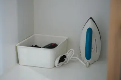 a white box with a charger and a hair dryer at Uptown BGC Luxury 1br Suite with Fast Wifi in Manila