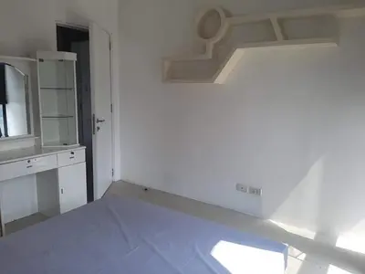 a white room with a kitchen with a counter top at Spacious 2 Bedroom Unit with Pool in Manila