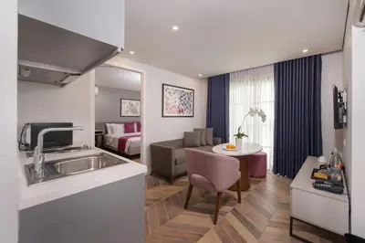 a kitchen and living room with a sink and a living room at The Belamy House Managed by HII in Manila