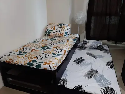two beds sitting next to each other in a room at Family Staycation 2 with Pool in Manila