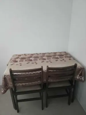 a table and two chairs sitting next to a wall at Family Staycation 2 with Pool in Manila