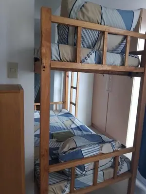 a couple of bunk beds in a room at Family Staycation 2 with Pool in Manila