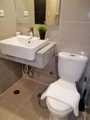 a bathroom with a white toilet and a sink at Uptown Parksuites Apartments Tower 1 BGC by PH Staycation in Manila