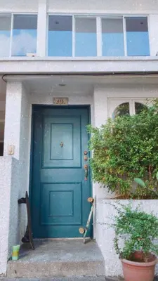a blue door of a house with a plant at Boho Inspired Home Near Rockwell in Manila