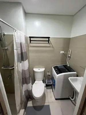 a bathroom with a toilet and a sink at SHORE TOWER 1 Staycation Near Mall Of Asia in Manila