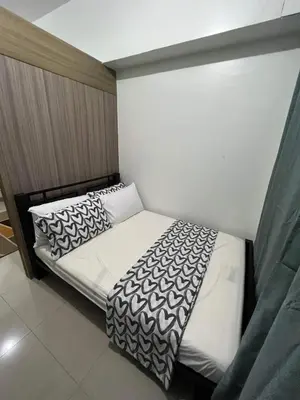 a small bedroom with two beds in it at SHORE TOWER 1 Staycation Near Mall Of Asia in Manila