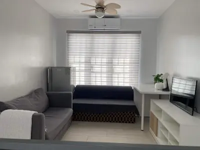 a living room with a couch and a window at Family Friendly Cozy Village Stay Sta Rosa Belair in Santa Rosa