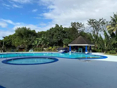 a large swimming pool with a gazebo at Family Friendly Cozy Village Stay Sta Rosa Belair in Santa Rosa