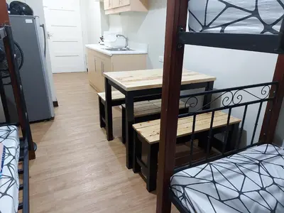 a small kitchen with a table and a bunk bed at Flair Towers STUDIO ROOMS Staycation in Manila