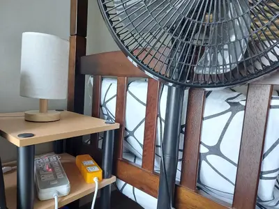 a room with a book shelf and a fan at Flair Towers STUDIO ROOMS Staycation in Manila