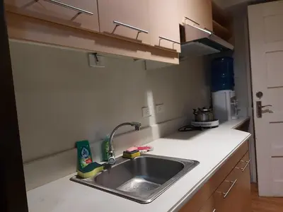a kitchen counter with a sink in a kitchen at Flair Towers STUDIO ROOMS Staycation in Manila