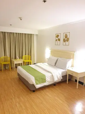 a bedroom with a bed and two chairs and a table at SAB R.CONDOTEL and room rental in Manila