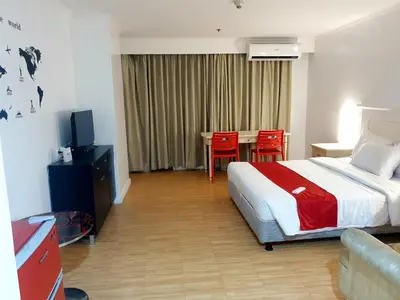 a hotel room with a bed and a table and chairs at SAB R.CONDOTEL and room rental in Manila